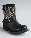 Ash's boots are full speed ahead with the moto trend. Riveting rows of studs and darkened crystals rev up a tough-chic silhouette.