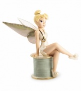 Disney's Tinkerbell sits primly atop a spool of thread in this vividly detailed porcelain figurine by Lenox. Accented with 24-karat gold.