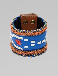 A wide cuff of bright leather, edged with golden beads and chains, stitched in colorful cord, with a center bugle-bead design.LeatherGoldtoneCotton backingLength, about 8½Width, about 2¾Stud snap closureImported
