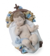 A true bundle of joy, this baby Jesus figurine snuggles up to a powder-blue blanket in a basket that's decorated with blooms and entirely handcrafted in premium Lladro porcelain.