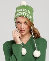 An adorable knit ski hat with an intarsia I Need A Vacation and pom-pon embellished braid ties.