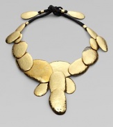 A striking series of multi-sized hammered discs makes a glowing statement in this bold, golden design.BrassCotton cordingLength, about 48 (adjustable)Tie closeImported