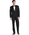 It's a formal affair. Dress to impress in this slim-fit tuxedo suit from Calvin Klein.