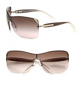 Ultra-lightweight in rimless metal, these over-sized shield sunglasses evoke an eternally cool feeling. Available in pale gold with brown gradient lens or gunmetal with gray gradient lens.Metal logo templesUV400 lensMade in Italy 
