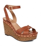 From day to night in the blink of an eye. The Raven sandals by Vince Camuto are perfect at any time with their woven wicker wedge and wraparound ankle strap with dainty buckle.