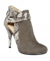 GUESS blends exoticism with richness with the Conetta booties. The kid suede and snake print upper mingles with cut-out details, ankle straps and elevated heel. The ideal partner for skinnies or a mini skirt.