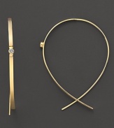 A single diamond gleams from the center of these wire-through 14K gold earrings.
