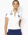 An iconic polo shirt is crafted in a slim stretch silhouette from breathable cotton mesh and accented with bold country embroidery to celebrate Team USA's participation in the 2012 Olympics.