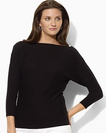 Channel modern elegance in the Jezzy sweater, rendered in a luxuriously soft blend of silk and cashmere with dramatic dolman sleeves and chic buttons at the neckline.