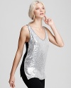 Work the coolest of contrasts in this ultra-glam DIANE von FURSTENBERG top--silver-sequined on the front and sleek black on the back. Streamlined with luxurious leather pants, the finish is a holiday masterpiece.