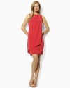 The classic shift dress is given a feminine update with an elegant draped front for romantic movement.