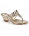 Eye-catching elegance. Shining metal accent highlight the beautiful straps of the Ivy wedge sandals by Sofft.