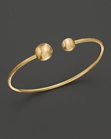 Bold, textured beads anchor this 18K yellow gold bangle. From the Marco Bicego Africa Collection.