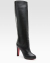 Lustrous leather knee-high style with a covered heel and platform. Self-covered heel, 4 (100mm) Covered platform, ¾ (20mm) Compares to a 3¼ heel (80mm) Shaft, 17 Leg circumference, 14 Leather upper Pull-on style Leather lining Signature red leather sole Padded insole Made in Italy