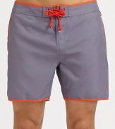 A comfortable, quick-dry look with piped detail and brilliant color that revives a classic beach style. Drawstring waistSide, back pocketsMesh liningInseam, about 6PolyesterMachine washImported 