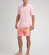 Return to the deep in this colorful tropical-print style. Drawstring/elastic waist Two side slash pockets Back flap pocket Quick-dry convenience Inseam, about 6 Mesh lining Nylon; machine wash Imported