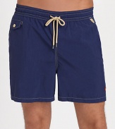 The classic Traveler swim short is rendered in sleek, quick-drying microfiber in a vibrant plaid pattern for cool, casual beach style.Elastic waistband with drawstring tie closureSide slash pocketsBack waist drainage grommetsBack flap patch pocketMesh liningInseam, about 4¾NylonMachine washImported