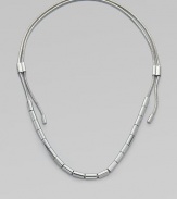 An edgy piece in sleek silvertone with oblong beads on a textured snake chain. Silvertone brassLength, about 37Sliding adjustable slip-on styleImported 