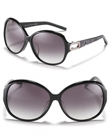 Turn heads in these oversized round sunglasses with open metal temples and reptile print along arms. Turn heads in these oversized round sunglasses with open metal temples and reptile print along arms.