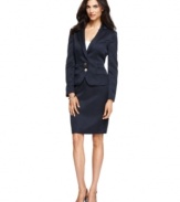 Calvin Klein's textured skirt suit features tailored details throughout, like the seamed waist, double flap pocket and low two-button closures on the jacket.