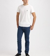 An embroidered anchor detail stands out against the pure white cotton background of a perfect tee. CrewneckLogo embroideryCottonMachine washImported