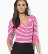 A deep split neckline finished with silver-toned buttons lends modern allure to a classic striped Henley in soft ribbed cotton.