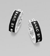 Sleek huggie hoops, embossed with the designer's name in golden letters. Enamel Palladium and rhodium-plated brass Diameter, about ½ Pierced Imported 