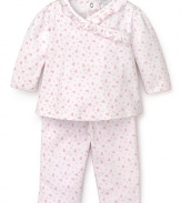 Rendered in heart print Pima cotton, this pink and white Kissy Kissy set features a ruffle trim top and basic pants.