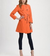 An ultra-feminine version of a classic, beloved design, this is a sleek and flattering outerwear piece. Round neckEpaulettesButton frontGun flapBelted designAbout 36 from shoulder to hem50% cotton/50% nylonDry cleanImported