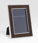 An elegant, silverplated brass frame, wrapped in alligator-embossed leather. Arrives in a gift box Accommodates a 5 X 7 photograph Overall: 7 X 9 Imported 