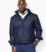 A classic-fitting lightweight windbreaker in high-performance water-resistant microfiber is equipped with a concealed zip-in hood for versatile protection.