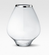 A masterful balance between strength and poetry, handcrafted in glass with a bulb-like shape that does justice to your most artful flower arrangements. From the Grace CollectionGlass with stainless steel rim8¼H X 7 diam.Hand washImported