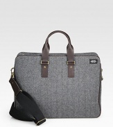 Inspired by suiting fabrics, this wool herringbone is a classic men's fabrication, complete with a leather strap and handles and interior functionality including a laptop sleeve and zip pocket.Zip closureDouble top handlesAdjustable shoulder strapWool/leather17W x 13H x 6DImported