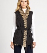 Plush coyote fur lends a luxuriously warm touch to this reversible, belted topper.Natural coyote furV-neckSleevelessButton-frontBelted waistbandSide-seam pocketsPrincess seamsAbout 29 from shoulder to hemPolyester rainsilkDry clean by fur specialistImportedFur origin: USA