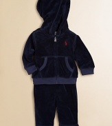 This coordinating athletic set includes a classic full-zip hoodie and a matching sweatpant in soft, cozy velour. Hoodie Attached hoodLong sleevesFull-zip frontSplit kangaroo pocketRibbed cuffs and hem Sweatpants Elasticized waist with tieMock fly87% cotton/13% polyesterMachine washImported