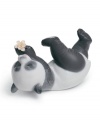Panda at play! A lovable black and white bear tumbles onto his side, pawing at a single bloom in Lladro's artfully crafted porcelain figurine.