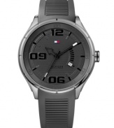 Stylish sport watch that will have you on trend while in the gym, by Tommy Hilfiger. Watch crafted of gray ribbed silicone strap and round stainless steel case. Gray dial features numerals at six, nine and twelve o'clock, applied stick indices, date window at four o'clock, three hands and iconic flag logo at twelve o'clock. Quartz movement. Water resistant to 50 meters. Ten-year limited warranty.