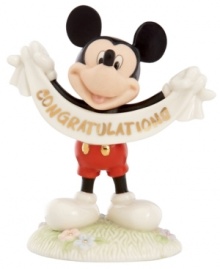 A cute memento of a major accomplishment, Mickey Mouse extends his congratulations with a gold-lettered banner in this fine china Disney figurine by Lenox.  Qualifies for Rebate