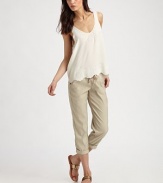Wear-with-anything silk v-neck has a scalloped hem, v-back and intricate perforations. V-neckSleevelessScalloped hemV-backSilkDry cleanImportedModel shown is 5'10 (177cm) wearing US size Small.