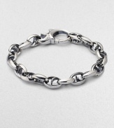 Bold oval links of polished sterling silver have not-so-sinister curved spikes in their centers.Sterling silver Length, about 8½ Lobster clasp Imported