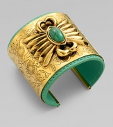 A striking relief design with a colorful turquoise stone is the centerpiece of a wide, delicately etched golden cuff layered over a bright leather interior.TurquoiseLeatherGoldplatedDiameter, about 2¼Width, about 2Made in France