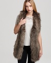 In plush faux fur, Black Halo's Braiden vest lends a cozy layer over a silk tee and black skinnies.