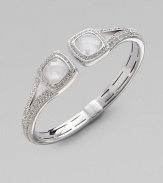 Two faceted doublets surrounded by dazzling stones on a stone encrusted bangle. Rhodium plated brassCrystalsCubic zirconiaCeramicDiameter, about 2¼ Hinged closureImported 