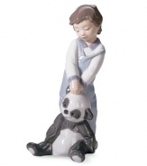 Totally inseparable, the cute little boy and his cherished panda bear from Lladro's First Discoveries figurine evoke the sweet innocence of youth in glazed porcelain.