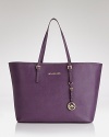 Join the jet set with this Saffiano leather tote from MICHAEL Michael Kors. Its roomy silhouette holds all your travel essentials, so carry it when it's time to take off.