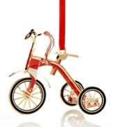 Feel like a kid on Christmas morning with a shiny red and gold tricycle outfitted with streamers and a bell. From ChemArt.