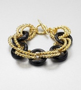 A graphic link style in 22k goldplating and glossy resin. Resin22k goldplatingLength, about 7.5Toggle closureMade in USA