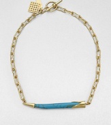 From the Horn Collection. A tapered horn-shaped pendant with the rich veining of turquoise suspends horizontally from an open golden chain for an intriguing look.Natural stone18k goldplatedChain length, about 18Pendant width, about 2.5Toggle closureMade in USA