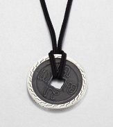 From the Classic Chain Collection. The center of this striking pendant has the look of an ancient coin with its square hole and blackened finish, set in a distinctive carved setting of polished sterling silver and hanging from a black cord.Sterling silverBlack fabric cordCord length, about 22 to 24 (adjustable)Pendant diameter, about 1.75Lobster claspMade in Bali