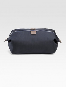 A convenient travel bag in dobby-woven nylon, trimmed with leather and backed with polyurethane for durability and water-resistance. Zip closure Die-cast hardware Interior zip pocket Cotton lining 9¾W X 5½H X 5¼D Imported A convenient travel bag in dobby-woven nylon, trimmed with leather and backed with polyurethane for durability and water-resistance. Zip closure Die-cast hardware Interior zip pocket Cotton lining 9¾W X 5½H X 5¼D Imported